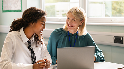 Female teacher and student at a laptop